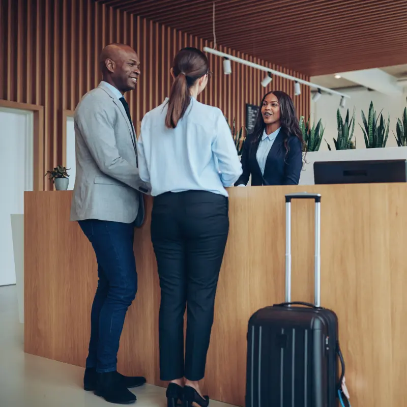 friendly customer service representative checking in hotel guests